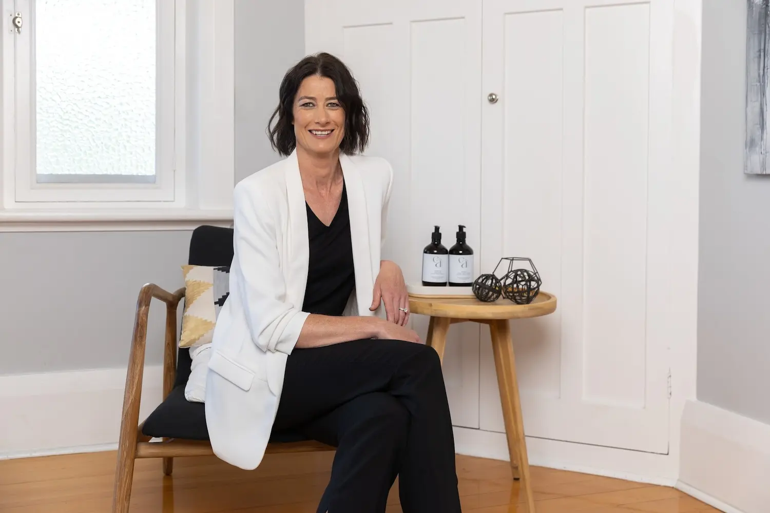 Owner Janelle smiling in shot with her products as the new owner.